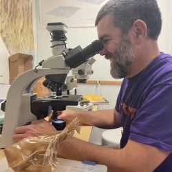 Brian Perry looking in a microscope